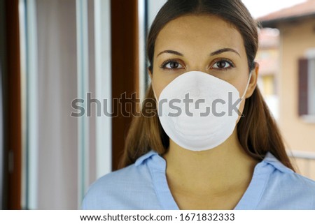 COVID-19 Pandemic Coronavirus Woman Nurse with Mask in hospital or quarantine home isolation for virus SARS-CoV-2. Girl voluntary isolation surgical mask on face against Coronavirus Disease 2019. Royalty-Free Stock Photo #1671832333