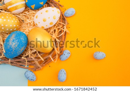 Easter golden decorated eggs on yellow background. Minimal easter concept. Happy Easter card with copy space for text. Top view, flatlay.
