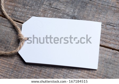 Close up of a note and a clothes peg on grunge wooden background with clipping path 