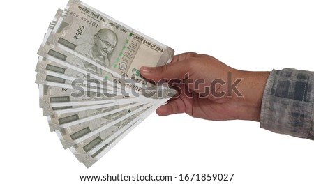 Hand holding New 500 rupees Indian notes against white background Royalty-Free Stock Photo #1671859027