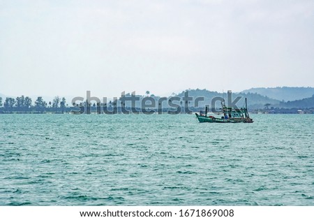 Old fishing boat on the background of the island