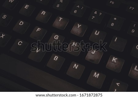 Dark background based on an old shabby keyboard. Shabby keys. Computer keyboard