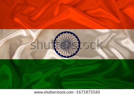 photo of the national flag of India on a luxurious texture of satin, silk with waves, folds and highlights, close-up, copy space, concept of travel, economy and state policy, illustration