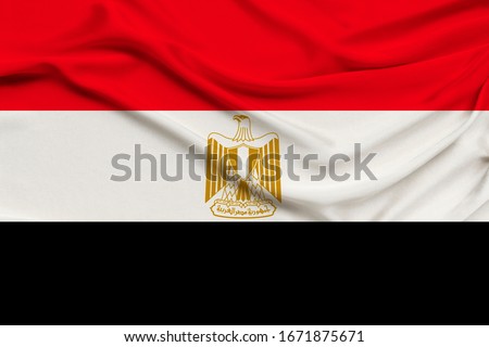 photo of the national flag of the state of Egypt on a luxury texture of satin, silk with waves, folds and highlights, close-up, copy space, illustration