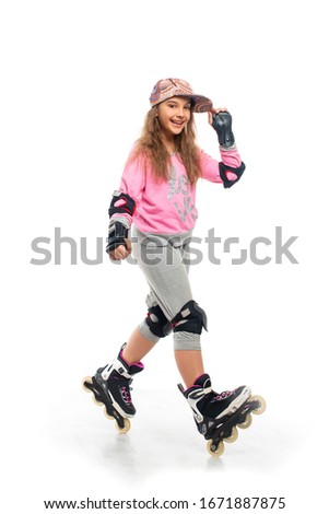 Shot of young teenager girl wearing  tracksuit and defense of fun rollerblading.  The concept of a happy childhood,  healthy lifestyle of youth