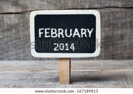 February 2014 on Small wooden framed blackboard with wooden background