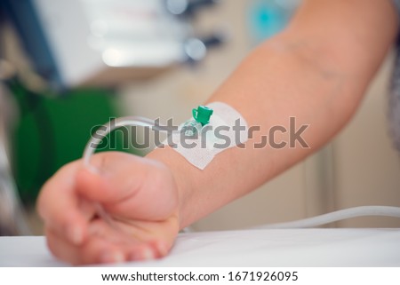 Iv fluid, intravenous with sodium chloride applying to the patient hand in the hospital.  Royalty-Free Stock Photo #1671926095