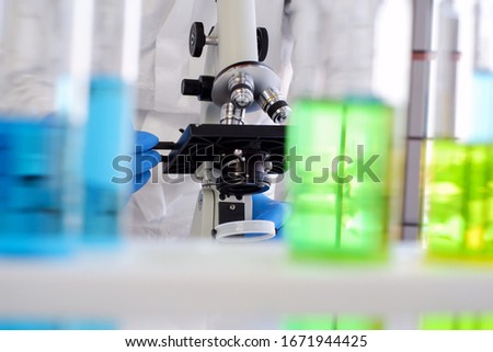 Researchers are sending microscopes to find a cure for the virus. There is a test tube blurred in the foreground. Research concepts in communicable disease prevention and control laboratory Royalty-Free Stock Photo #1671944425