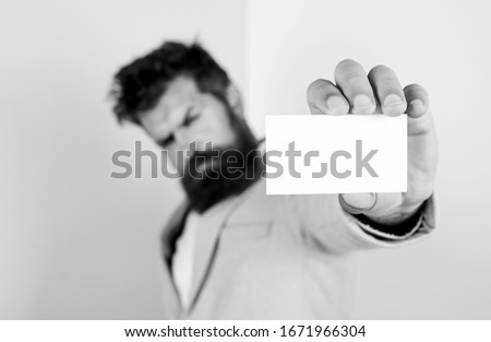 blank piece of paper. barbershop concept. best barber master. barber shop for gentlemen. brutal male beauty. serious bearded man business card. copy space. selective focus. man hold credit card.
