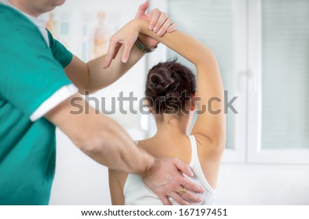 Chiropractor massage the female patient spine and back Royalty-Free Stock Photo #167197451