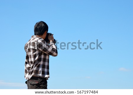 Man takes a picture of blue sky