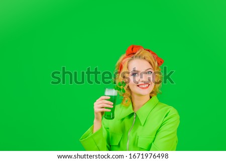 St Patricks Day. Clover. Saint Patrick's Day. St Patricks Day. Smiling woman holds glass with green beer. Green beer. Green beverage with clover. Irish Traditions. Woman drinking beer in pub. Royalty-Free Stock Photo #1671976498