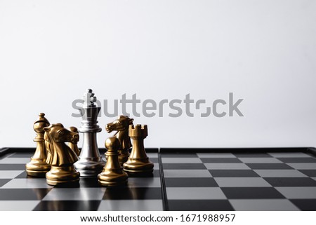 King stand surrounded by enemies. Refer to emergency situation, finding solution to solve the problem. Royalty-Free Stock Photo #1671988957