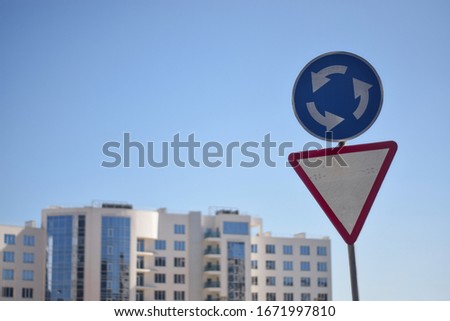 Traffic signs on the background of the building and the sky