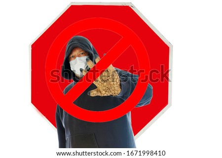STOP SIGN. A man wears a Hooded Sweat Shirt with a Paper Face Mask and holds out his MONSTER HAND in a Stop the Infection symbol. Coronavirus2019? Flesh Eating Bacteria? SARS? Monster Hand Disease.