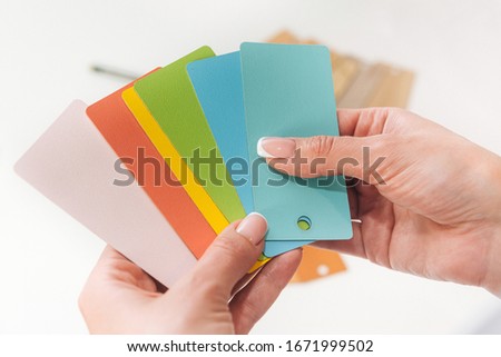 a set of color sample cards on a light background. color plates with the texture of different products. top view for color and material selection
