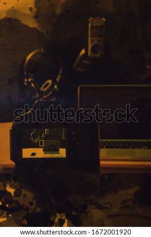 Composer workplace. Headphones, keyboard and a laptop. Computer music concept.With laptop computer, mobile phones.Vloggers , Interview, podcast, video recording in studio, yellow background