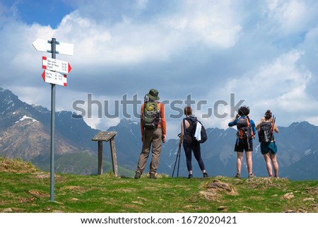 Group of young hikers admire the panorama the wild Val Grande National Park from the top of the mountain, Europe, Piedmont, Italy.