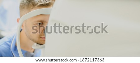 close up head of young patient fix in Tomography in Optical Coherence (OCT) equipment. Copy space for you text Royalty-Free Stock Photo #1672117363