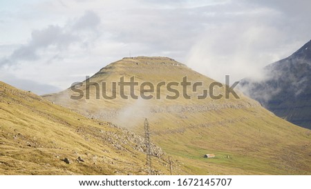 Klakkur and Suður á Nakki Mountain Peaks rising out of the Sea next to remote Klaksvík village in Northern Faroe Islands, Denmark.