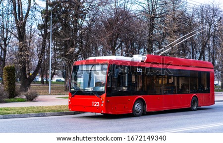 Trolleybus is moving along the road Royalty-Free Stock Photo #1672149340