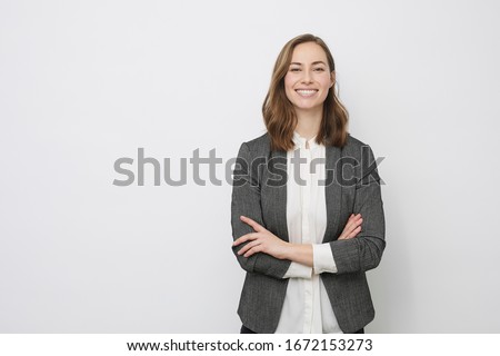 Confident business woman and person smiling at the camera looking professional and executive and having arms crossed, isolated on white background