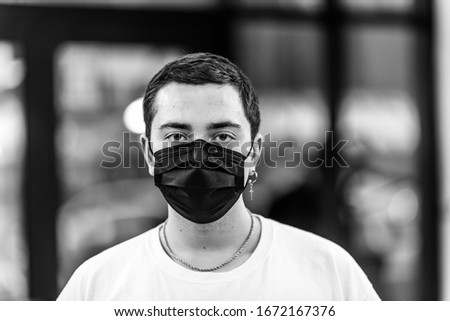 A man puts on a mask from a virus. Against Coronavirus Protection.