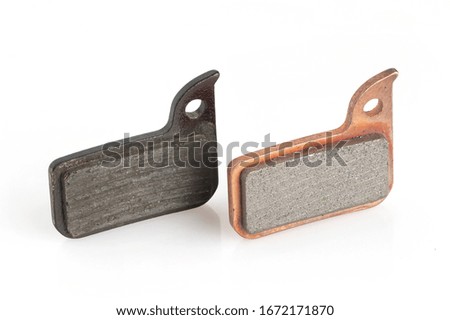 Old and new bicycle disk brake pads isolated on white background.