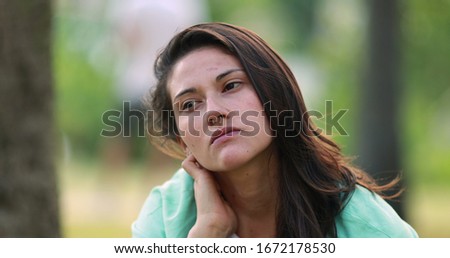 
Thoughtful woman at park. Pensive young millennial girl thinking about decision