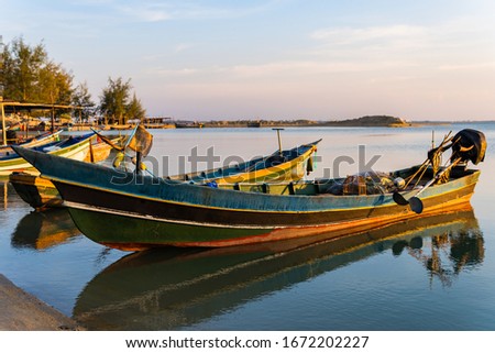 Coastal fishing boat on the sea and sunset sky in the evening 