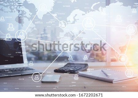 Computer on desktop with social network hologram. Multi exposure. Concept of international people connections. Royalty-Free Stock Photo #1672202671