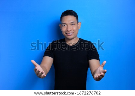Happy Asian man with clear and innocent smile face on blue background