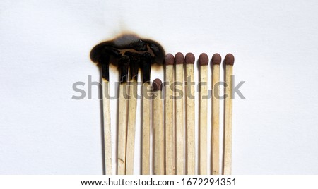 Matchsticks burn, one piece prevents the fire from spreading - the concept of how to stop the coronavirus from spreading: stay at home as #stayathome Royalty-Free Stock Photo #1672294351