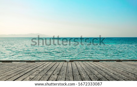 gray wooden pier of free space for your decoration and landscape of ocean with blue sky  Royalty-Free Stock Photo #1672333087