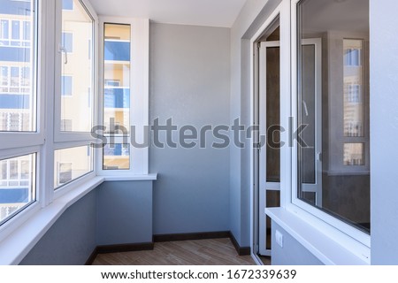 Glazed balcony in the new building, view of the entrance to the balcony Royalty-Free Stock Photo #1672339639