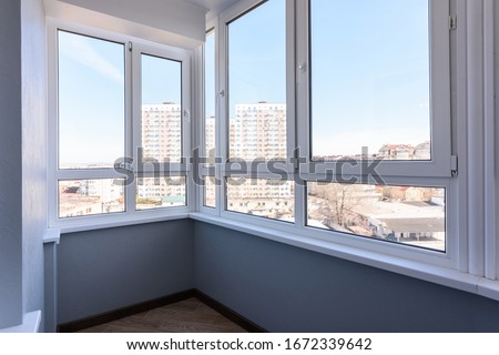 Glazed plastic balcony windows after renovation Royalty-Free Stock Photo #1672339642