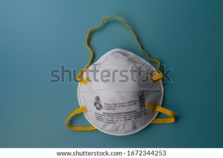 N95 respirators and surgical mask corona virus protection isolated on a blue background. Particulate Filtering Facepiece Respirators Royalty-Free Stock Photo #1672344253