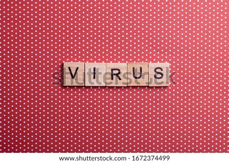 The inscription corona virus on a red background, top view. The epidemic of the covid-19 virus. Wooden cubes with letters.