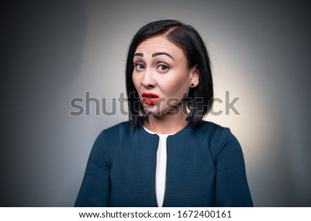 studio shot of brunette female has aggression and disgust