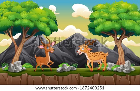 Happy deers playing at the hill landscape