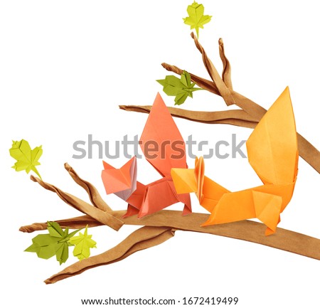 Curious origami cartoon squirrels on a branch on a white