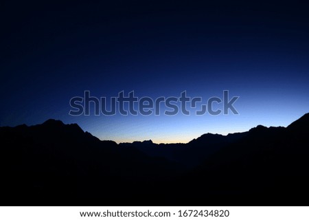 Mountain backdrop as a silhouette in the morning hours in Switzerland with clear skies