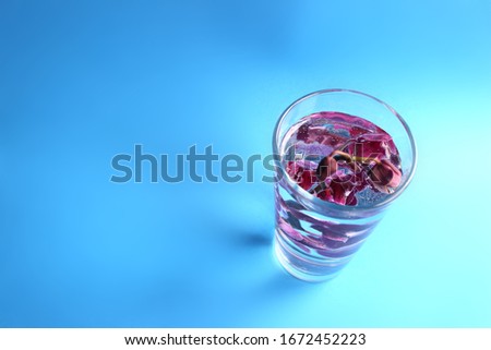 Blurred pink orchid in a glass with water. Bubbles on the flowers. Cosmetics concept. Organic cosmetics. Natural water. A fresh look.