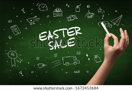Hand drawing EASTER SALE inscription with white chalk on blackboard, online shopping concept