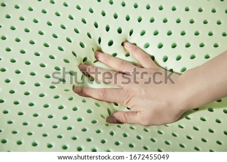 Keep hand pressed on latex pillow