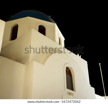 Santorini. Here is a building with arches in the night city                               