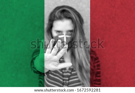 Girl in a mask against the background of the Italy flag. Stop Coronavirus. 