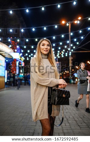 Attractive blonde posing against the backdrop of the night city