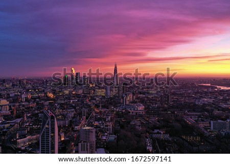 Photo shows beautiful sunrise at London where the sky is in pink and violet color.