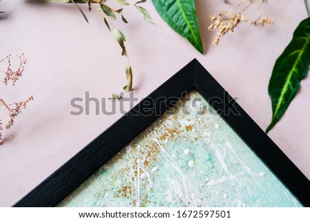 Abstract picture in black wooden frame. Spring home decor. Picture framing concept.